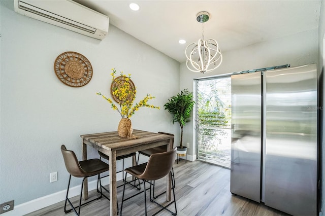 dining area featuring recessed lighting, a notable chandelier, wood finished floors, baseboards, and a wall mounted air conditioner