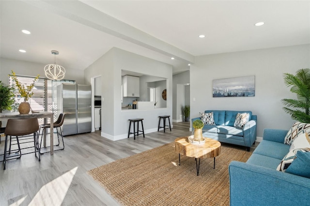 living room featuring lofted ceiling, recessed lighting, light wood-type flooring, and baseboards