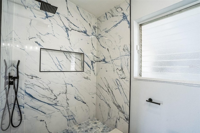 full bath with a marble finish shower and a wealth of natural light