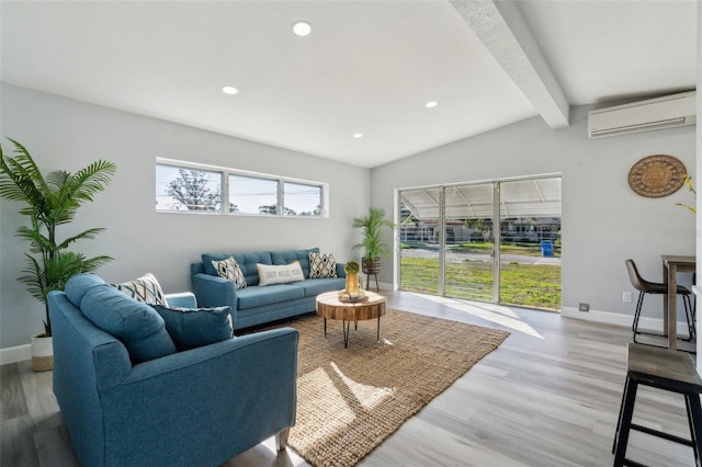 living area with a wall unit AC, light wood finished floors, lofted ceiling with beams, and baseboards