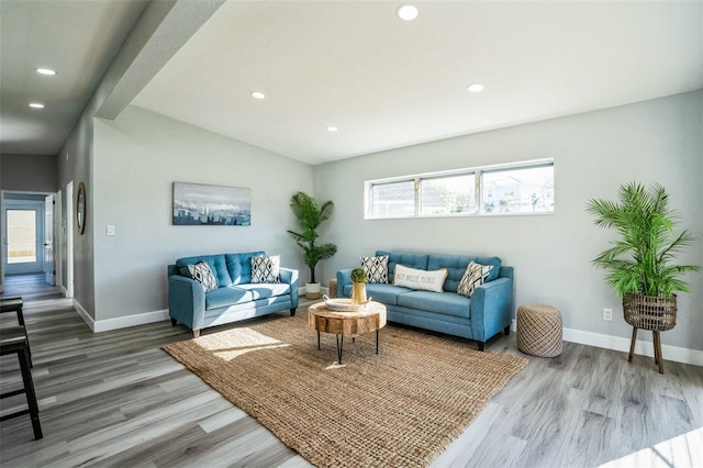 living room with vaulted ceiling, recessed lighting, wood finished floors, and baseboards