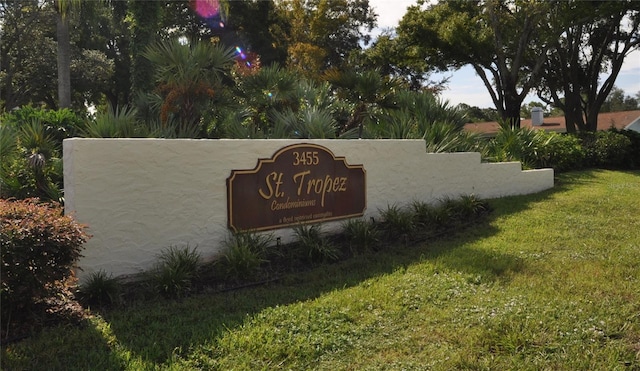 community / neighborhood sign with a lawn