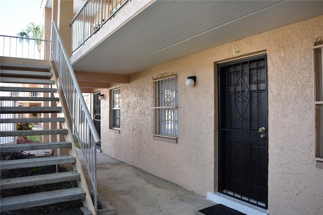 entrance to property with stucco siding