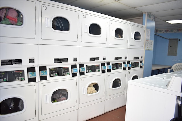 community laundry room with stacked washer and clothes dryer, electric panel, and separate washer and dryer