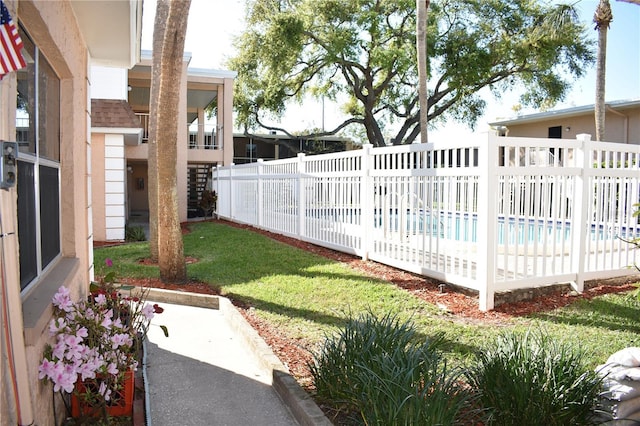 view of yard featuring fence and a fenced in pool