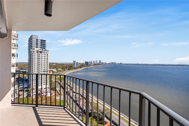 balcony featuring a water view and a city view