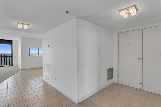 interior space featuring light tile patterned flooring and visible vents