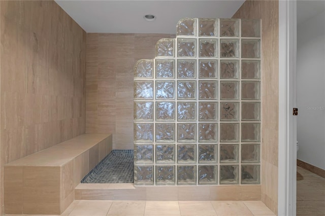 bathroom with tile patterned flooring, toilet, and walk in shower