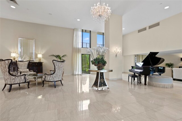 living area featuring recessed lighting, visible vents, a notable chandelier, and a towering ceiling