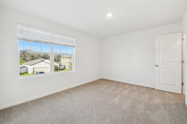 carpeted empty room with baseboards