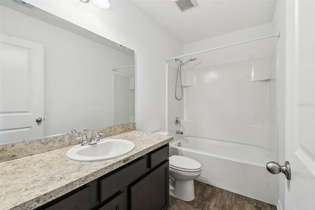 full bathroom featuring toilet, wood finished floors, vanity, and visible vents