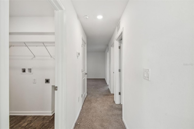 corridor featuring carpet floors, visible vents, and baseboards