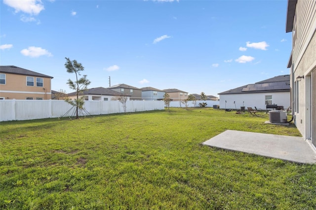 view of yard featuring central AC, a patio area, and a fenced backyard