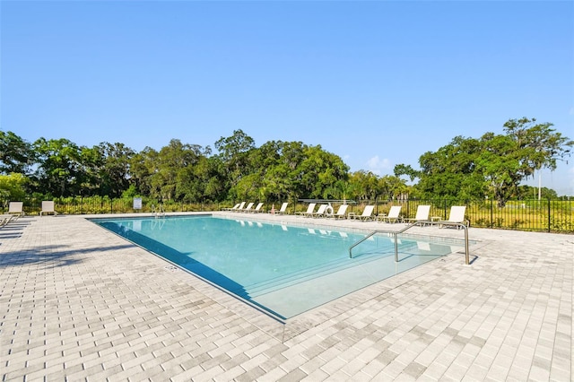 community pool featuring a patio area and fence