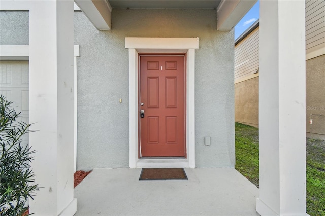 doorway to property with stucco siding