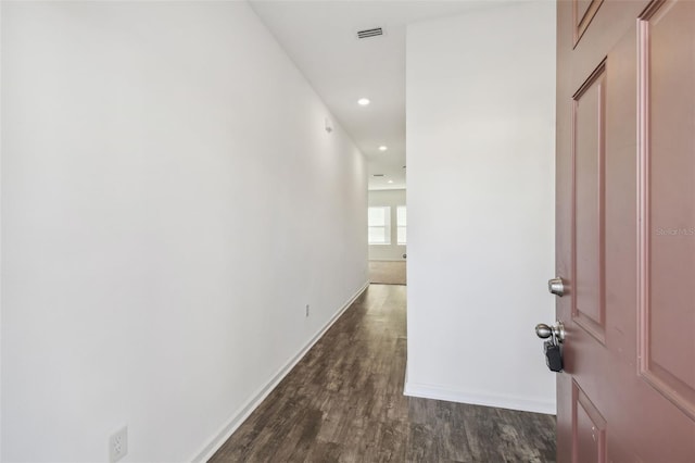 hallway with recessed lighting, visible vents, dark wood finished floors, and baseboards