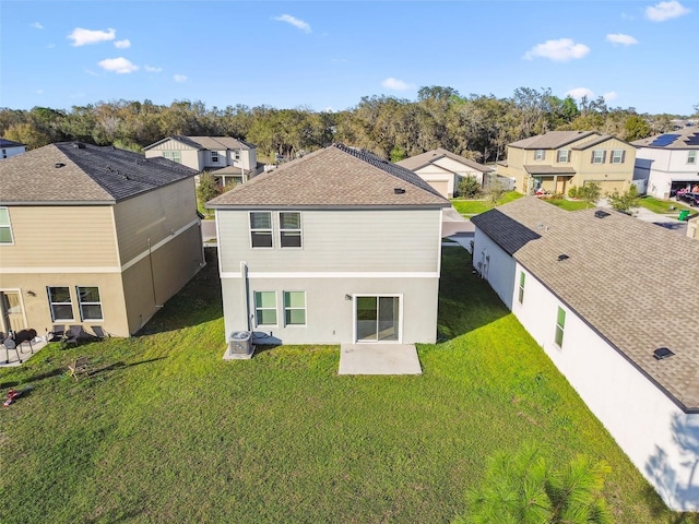 rear view of property featuring a patio area, a residential view, fence, and a lawn