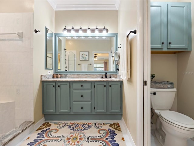 bathroom featuring a sink, toilet, crown molding, and tile patterned floors