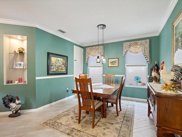 dining room with a textured ceiling, visible vents, and crown molding