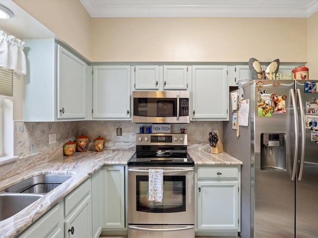 kitchen featuring light stone counters, a sink, appliances with stainless steel finishes, backsplash, and crown molding