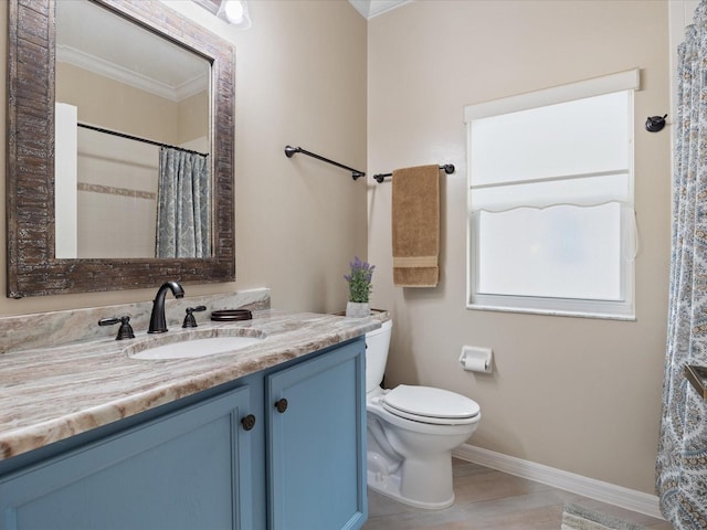 full bathroom featuring baseboards, toilet, ornamental molding, wood finished floors, and vanity