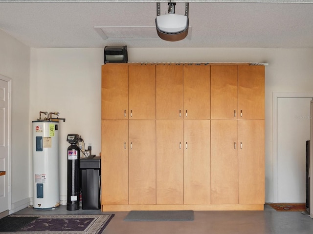 garage featuring water heater and a garage door opener