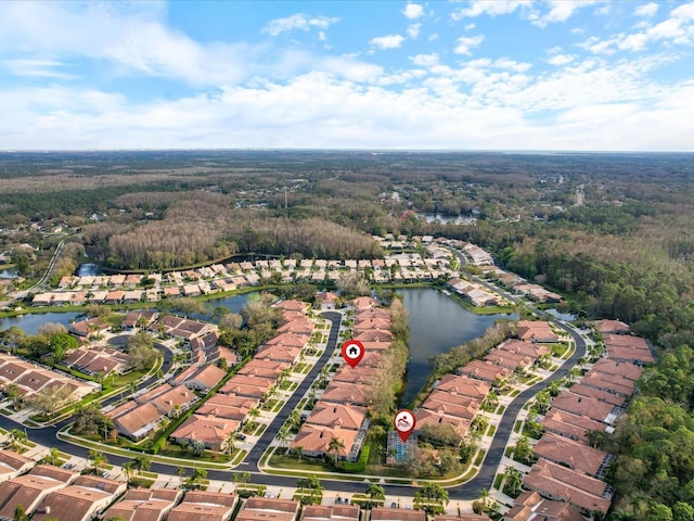 bird's eye view featuring a water view, a forest view, and a residential view