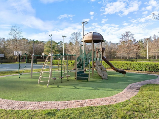 community play area with fence and a lawn