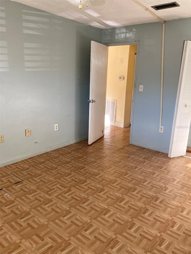 empty room with baseboards and visible vents