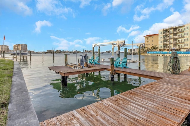 dock area with a water view and boat lift