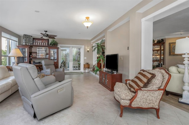 living room featuring ceiling fan, french doors, and light tile patterned flooring