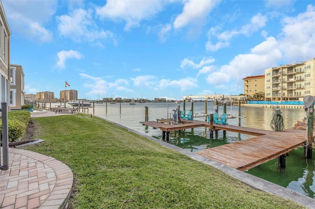 dock area with a yard, a water view, and boat lift