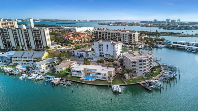 birds eye view of property with a water view and a city view