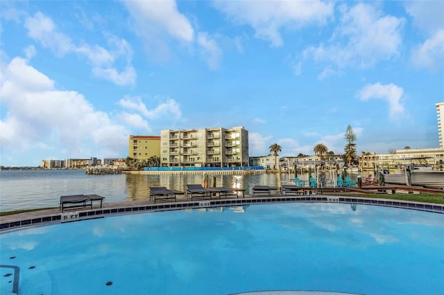 community pool featuring a boat dock and a water view