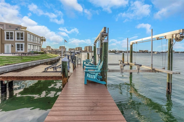dock area with boat lift and a water view