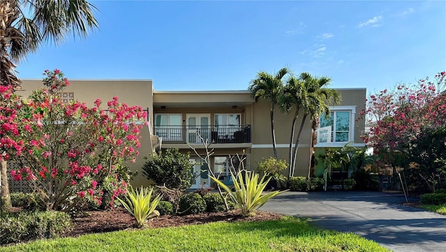 view of front of property with a balcony and stucco siding