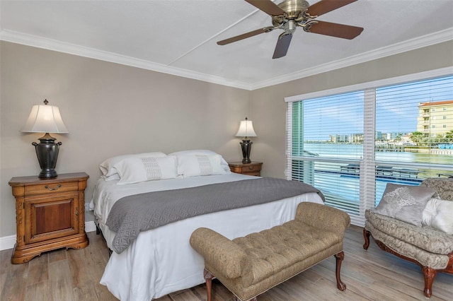 bedroom with ceiling fan, baseboards, crown molding, and light wood-type flooring