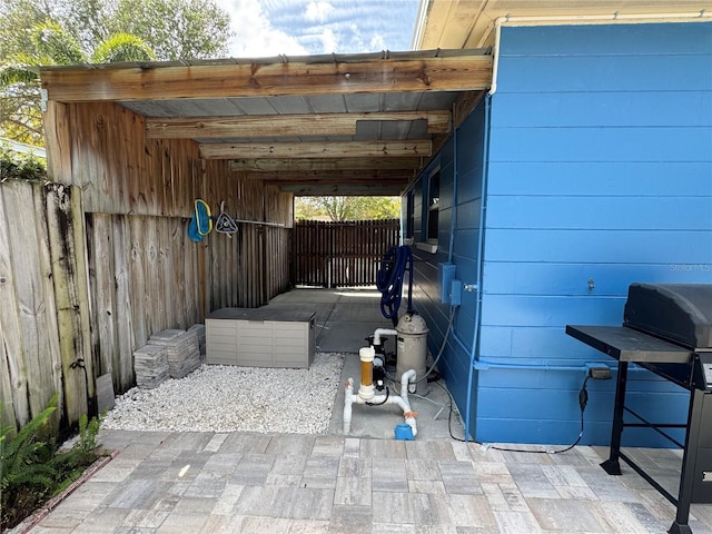 view of patio with fence and a carport