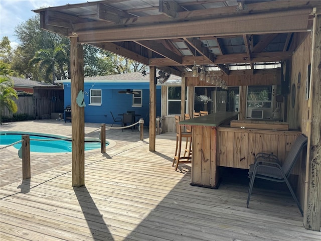 wooden terrace featuring a patio area, cooling unit, fence, and a fenced in pool