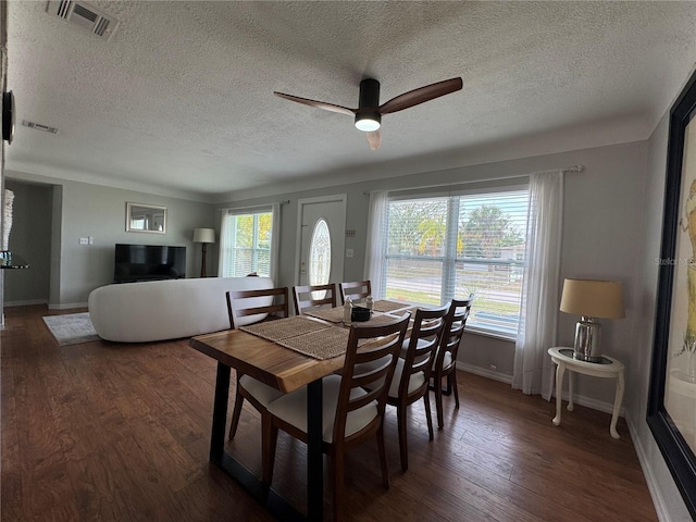 dining area with a ceiling fan, wood finished floors, visible vents, and baseboards