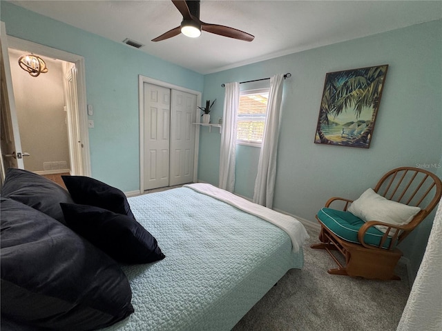 bedroom featuring a closet, visible vents, carpet flooring, ceiling fan, and baseboards