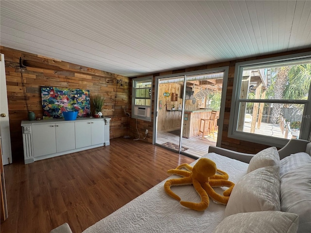 living room featuring wood ceiling, wooden walls, and wood finished floors