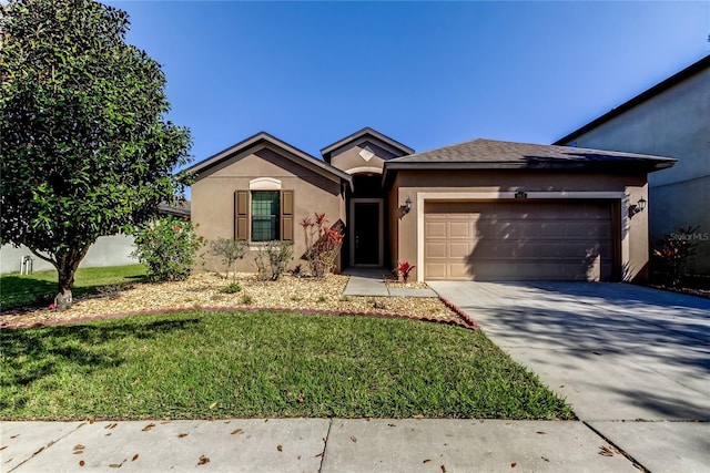 single story home featuring a garage, driveway, a front lawn, and stucco siding