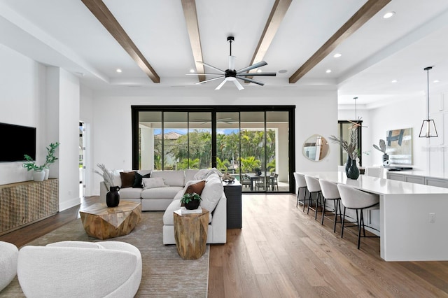 living room with baseboards, a ceiling fan, beamed ceiling, wood finished floors, and recessed lighting