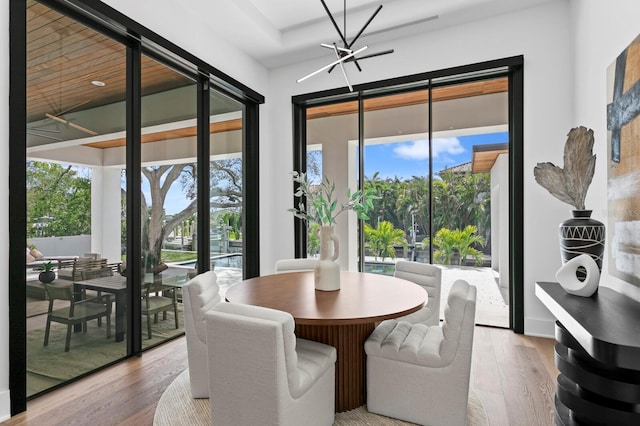 dining area with a chandelier and light wood-style flooring