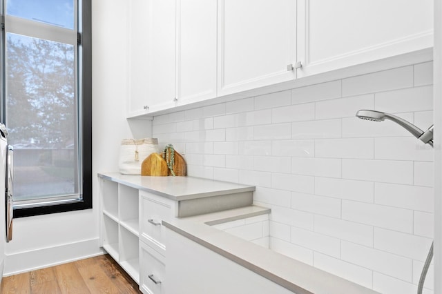 room details with decorative backsplash and wood finished floors