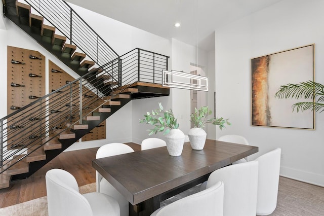 dining space featuring stairs, baseboards, wood finished floors, and recessed lighting