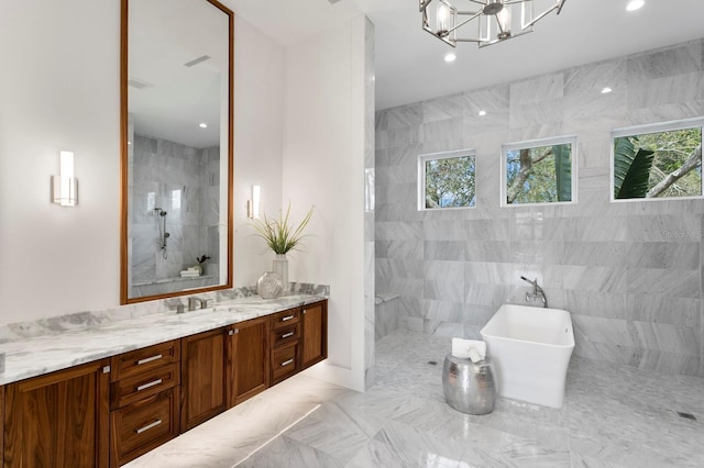 full bath featuring an inviting chandelier, a freestanding bath, vanity, a walk in shower, and recessed lighting