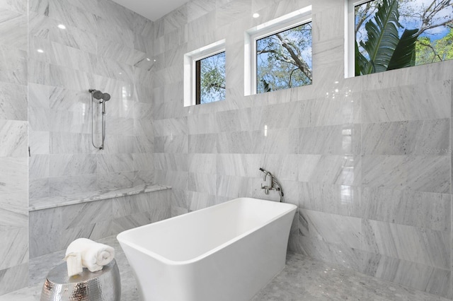 full bathroom featuring a freestanding bath, a sink, and walk in shower