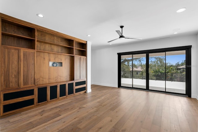 unfurnished living room with baseboards, a ceiling fan, wood finished floors, and recessed lighting